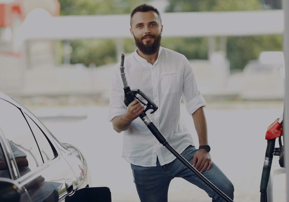 dark--man-pours-gasoline-into-tank-car-(1)